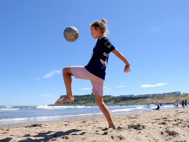 Jaxson shows off his beach football skills.