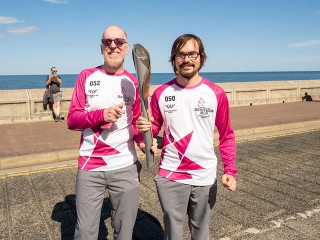 Chris Green and Niall Guite take the baton along Marine Drive.