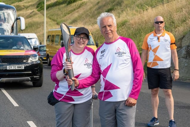 Claire Maxted Wiggins and David Wilson take part in The Queen's Baton Relay.