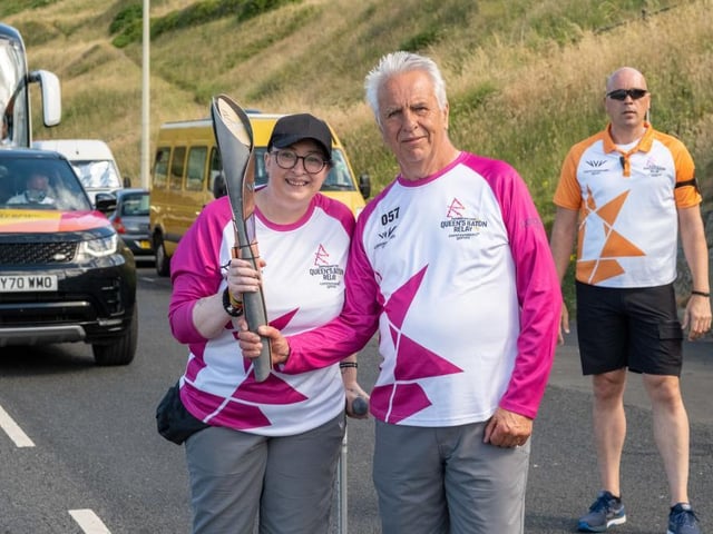 Claire Maxted Wiggins and David Wilson take part in The Queen's Baton Relay.