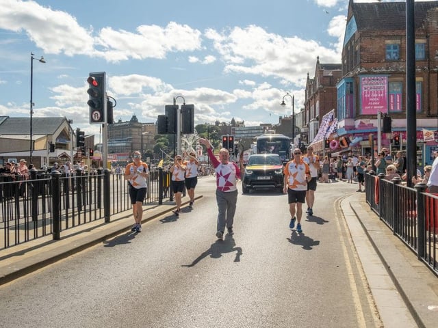 Antony Bakes takes part in The Queen's Baton Relay as it visits Scarborough South Bay.