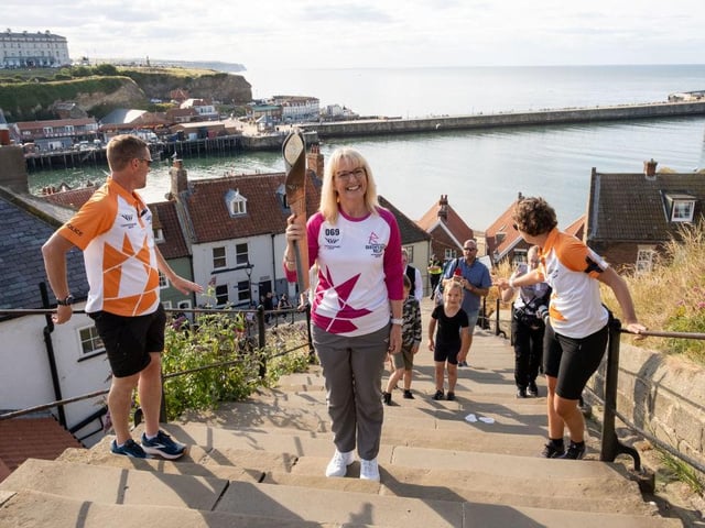 Julie Lee, Gary Matalon and Amy Gustin take part in the relay as it climbs the 199 steps on its way Whitby Abbey