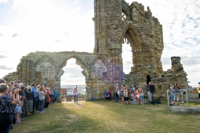 Suz Gregory takes part in The Queen's Baton Relay as it visits Whitby Abbey.