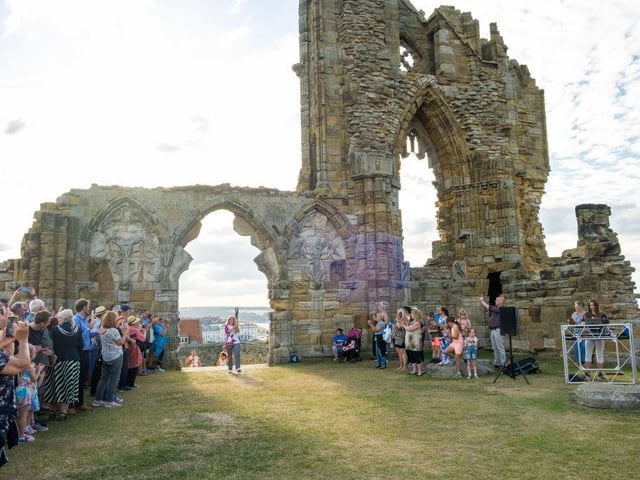 Suz Gregory takes part in The Queen's Baton Relay as it visits Whitby Abbey.
