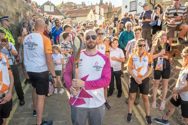 Bruce McClean takes part in The Queen's Baton Relay as it visits Robin Hood's Bay.