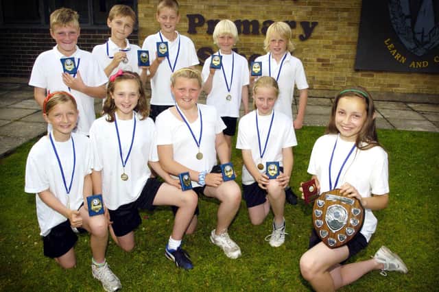 The Wheatcroft Primary School team winners of the Scarborough Schools Athletic Tournament with their medals and trophies.