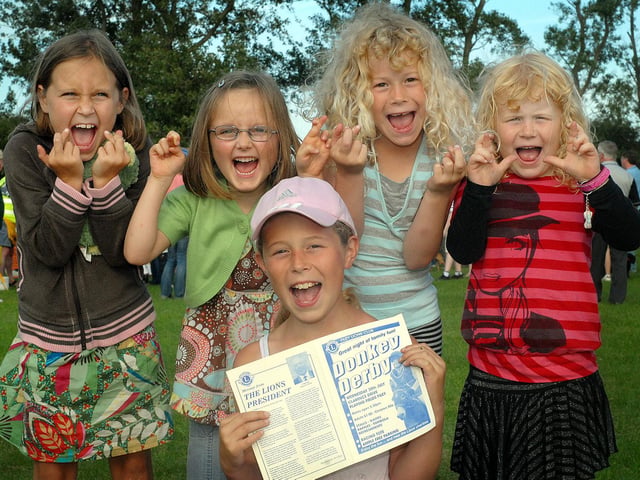 Filey's Donkey Derby: Kids keep their fingers crossed as they place bets.