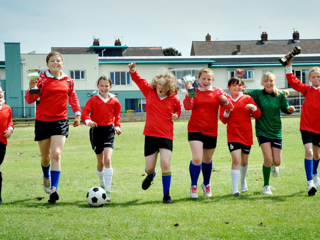 Triple trophy winning Barrowcliff junior girls football team celebrates in style after lifting the three trophies this last season.