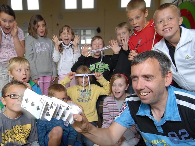 Newby and Scalby Primary School hosts a magic fun day. Pictured is magician Steve Brailsford who shows a card trick to the children.