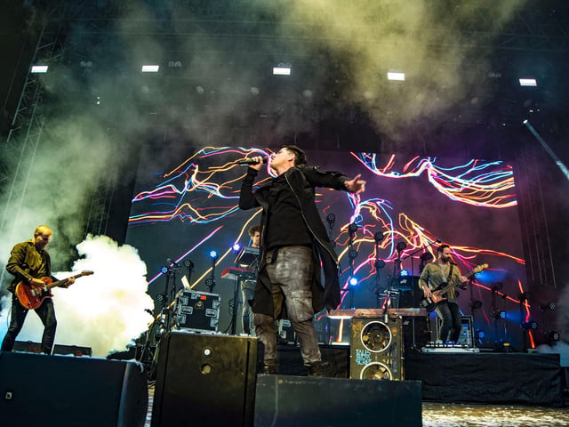 Superheroes "The Script" appear on stage
