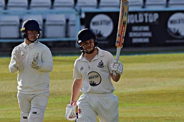 Duncan Brown raises his bat after making it to a superb century

PHOTOS BY SIMON DOBSON