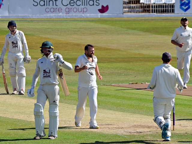 Dan Robson celebrates his first wicket