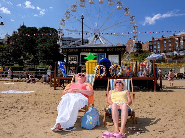 Beachgoers relax as temperatures soar.