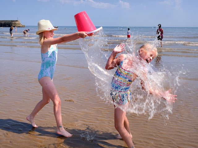 Amelia and Poppy splash, cool off and have fun.