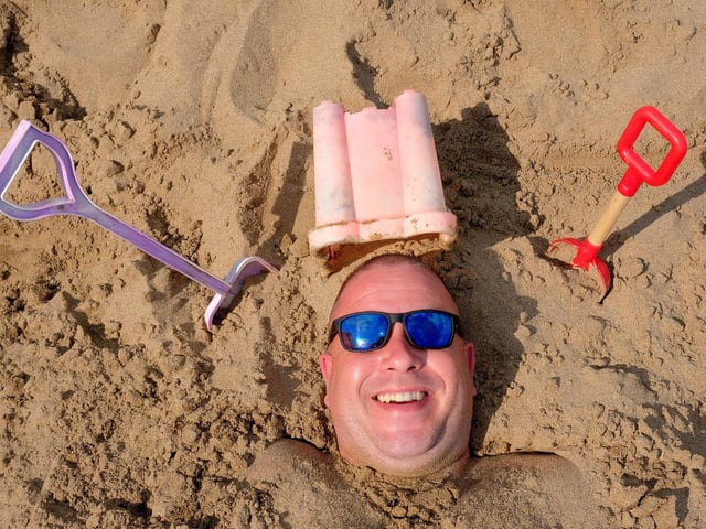 Paul Milne takes to the sand for shade.