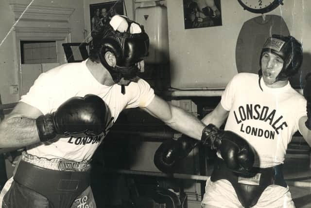 Bridlington boxer Roger Tighe is pictured sparring with Sir Henry Cooper.
