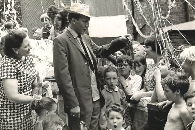 Roger is pictured on St George’s Road in Hull showing his Commonwealth gold medal to local children in 1966.