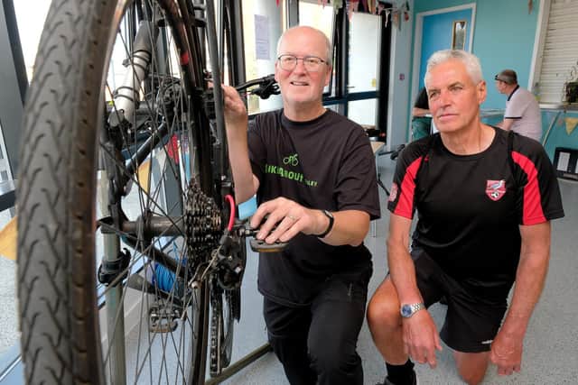 .Bob Houghton from Bikeabout Filey works on Dave Peacock's bike.