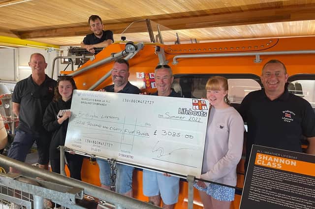 Abigail Holmes and Evie Pattison recently visited the lifeboat station to present the team with a cheque for £3,085. Photo courtesy of Bridlington RNLI