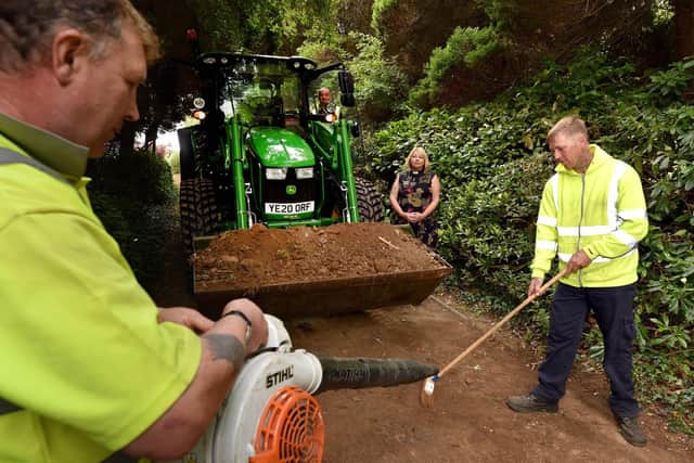 Rev. Shena Moray-Evans looks on as council staff clear the church driveway