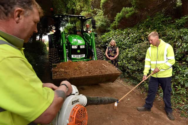 Rev. Shena Moray-Evans looks on as council staff clear the church driveway