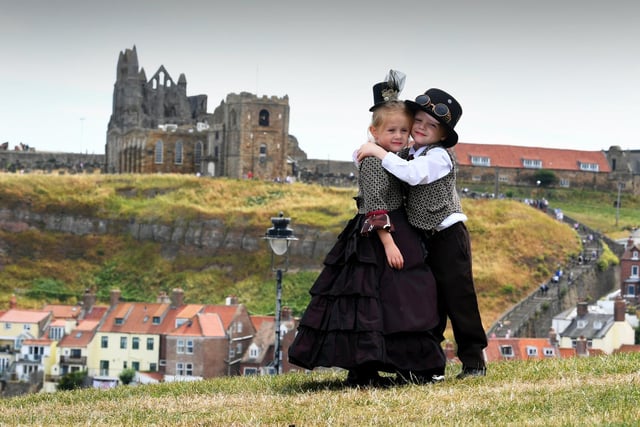 Isabella Hayton with her brother Matthew, aged 5, pictured with Whitby Abbey in the background.