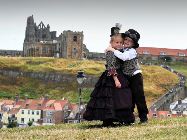 Isabella Hayton with her brother Matthew, aged 5, pictured with Whitby Abbey in the background.