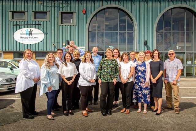 Angela Fletcher (green top, centre) with the Happy Futures team outside their new premises in Newchase Court. Happy Futures will be the main sponsor for this year's business awards.