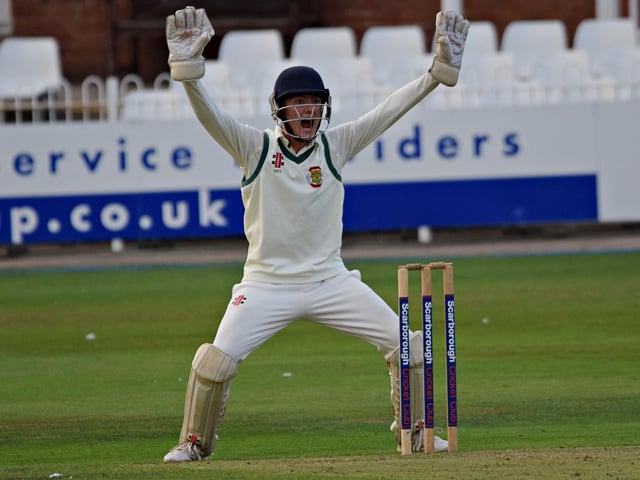 Flixton wicketkeeper Will Hutchinson appeals in vain