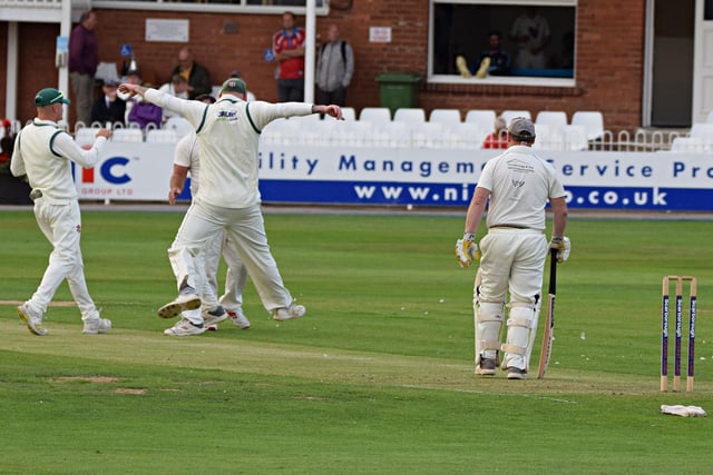 Flixton celebrate the wicket of Dave Greenlay