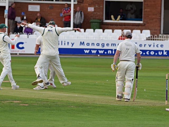 Flixton celebrate the wicket of Dave Greenlay