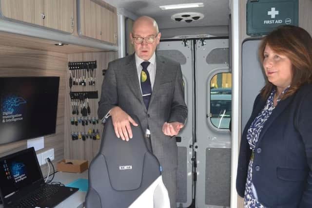 Detective Superintendent Jon Naughton gives Police, Fire and Crime Commissioner Zoë Metcalfe a tour of the mobile digital forensic laboratory.