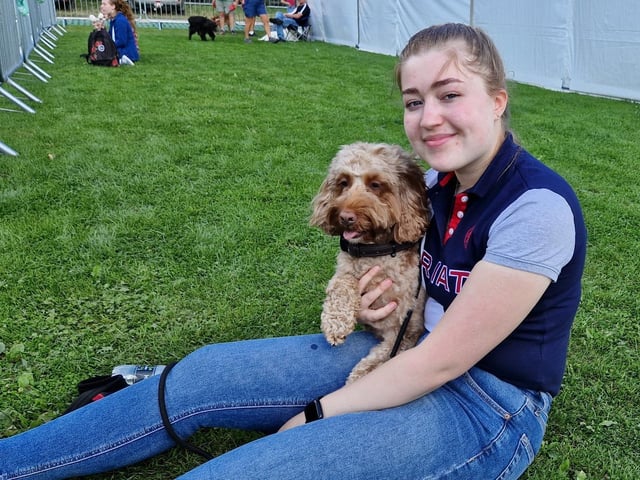 Waiting to watch the dog show, cockapoo Teddy with owner Yasmin from Wakefield.