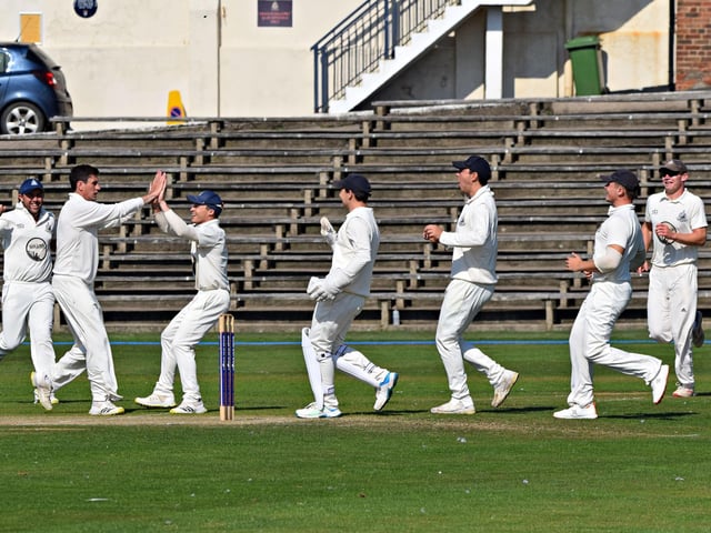Scarborough CC players race in to celebrate with Pat Roberts