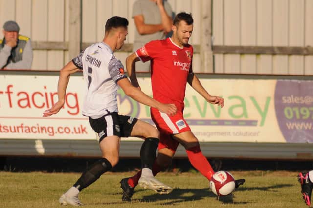 Striker Lewis Dennison in action for Brid Town