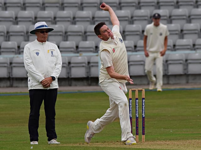 Guy Emmett bowling for the home side