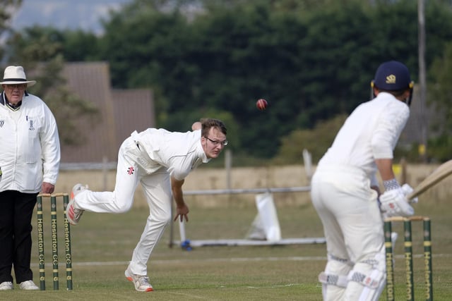 Brad Lewis in bowling action for Staithes at Heslerton
