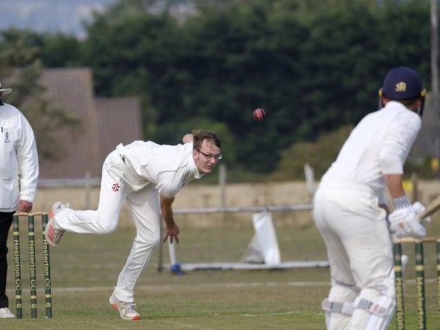 Brad Lewis in bowling action for Staithes at Heslerton