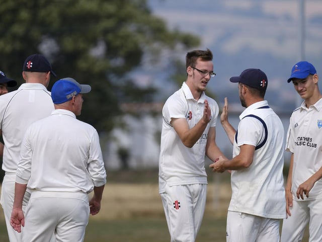 Brad Lewis celebrates with his teammates after claiming the wicket for Heslerton batter Andrew Slaughter