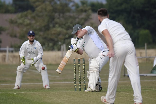 Heslerton's Tony Watson hits the ball into the offside