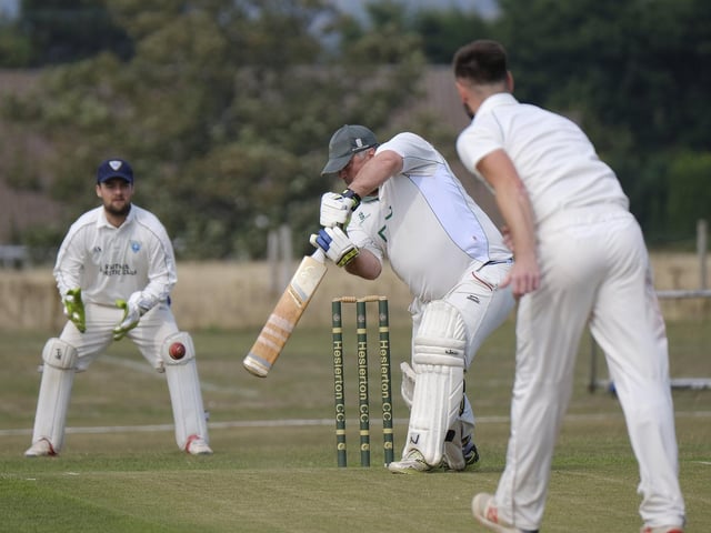 Heslerton's Tony Watson hits the ball into the offside