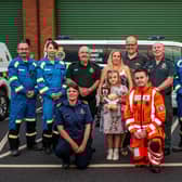 Donna Bates, husband John, and daughter Isabella are pictured with her team of life-savers from Yorkshire Ambulance Service, Yorkshire Air Ambulance and HM Coastguard. Photo submitted by Yorkshire Ambulance Service