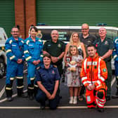Donna Bates, husband John, and daughter Isabella are pictured with her team of life-savers from Yorkshire Ambulance Service, Yorkshire Air Ambulance and HM Coastguard. Photo submitted by Yorkshire Ambulance Service