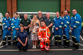 Donna Bates, husband John, and daughter Isabella are pictured with her team of life-savers from Yorkshire Ambulance Service, Yorkshire Air Ambulance and HM Coastguard. Photo submitted by Yorkshire Ambulance Service