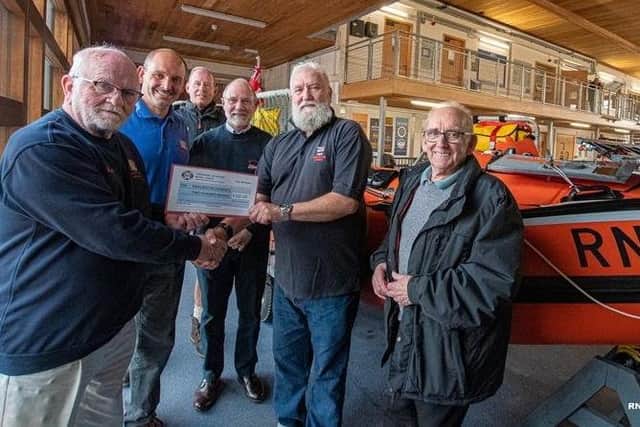 Ian Dewar (left) from the Yorkshire Veterans Model Group presents a cheque for £200 to Bob Taylor (Brid RNLI). Photo: Mike Milner/RNLI