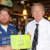 Sir Greg Knight MP (right) is presented with his “Parliamentary Champion” certificate by pub landlord Marc Johnson at the Black Swan in Brandesburton.