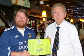 Sir Greg Knight MP (right) is presented with his “Parliamentary Champion” certificate by pub landlord Marc Johnson at the Black Swan in Brandesburton.