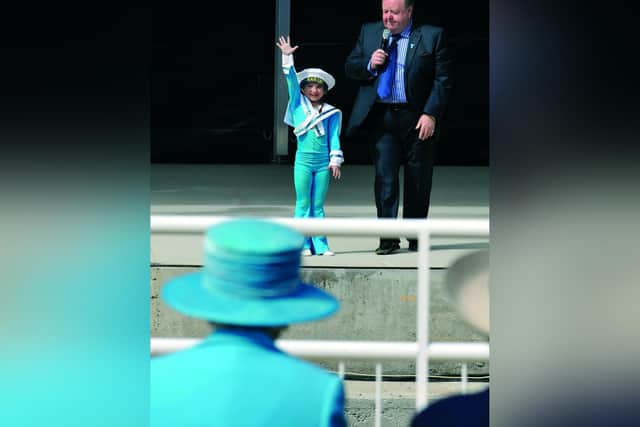 Tony Peers comperes the Open Air Theatre show in May 2010; young performer Lucy Hallam waves to the Queen.