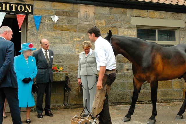 Damian Readman gives a horse-shoeing demonstration to the Queen and Duke of Edinburgh outside the Cloughton forge in 2010.