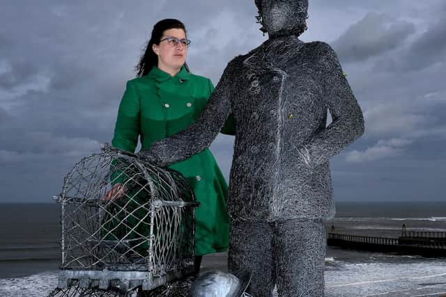 Zoe Taylor beside a statue from Emma Stothard to honour her great aunt Dora Walker. The Whitby Civic Society is now to dedicate a blue plaque to Whitby's first female skipper. Image by Richard Ponter.